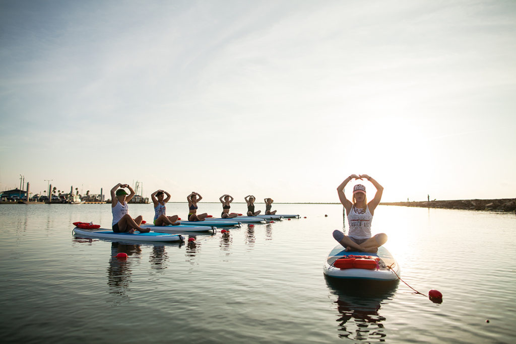 Sunrise on the water in Corpus Christi with Water Dog Floating Yoga